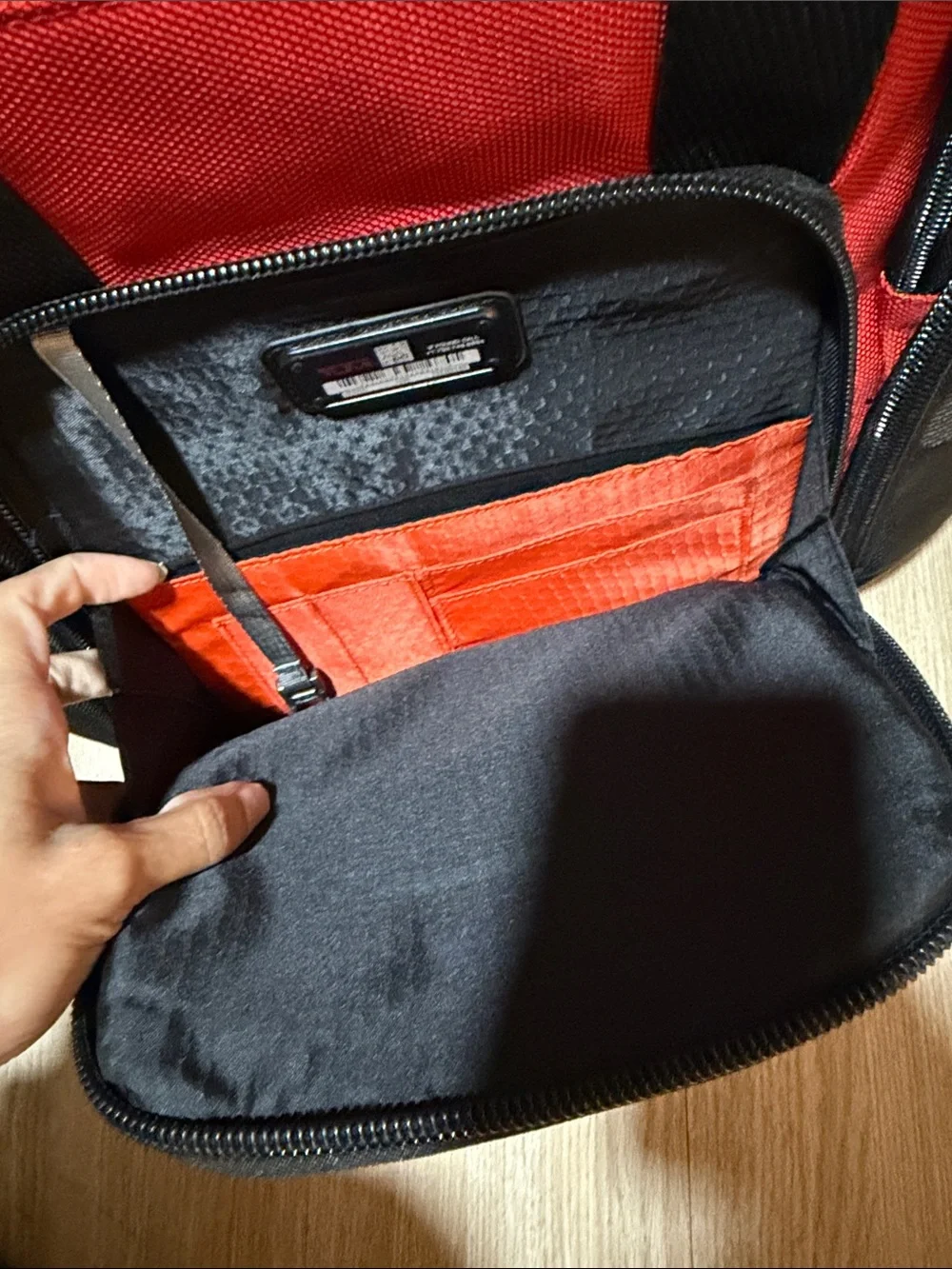 Tumi Red and Black Men/Women’s Backpack with Multiple Front Pockets
